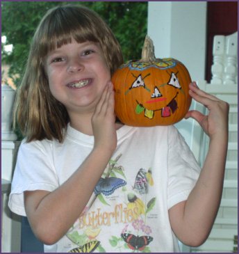 Diana holds up pumpkin