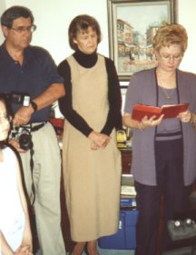 three grandparents reading from the ceremony book